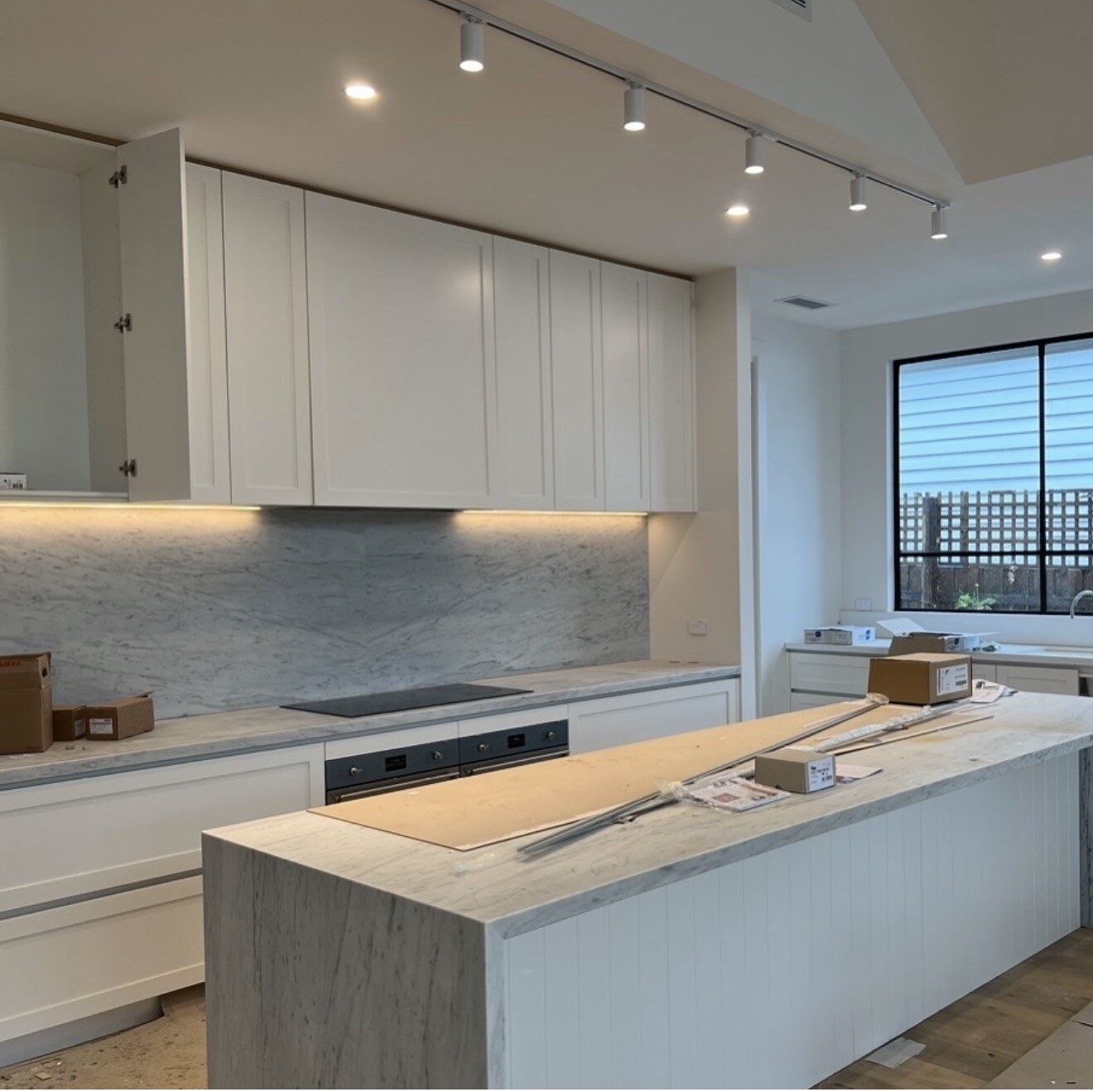 Kitchen with ceiling spotlights and under-cabinet lighting